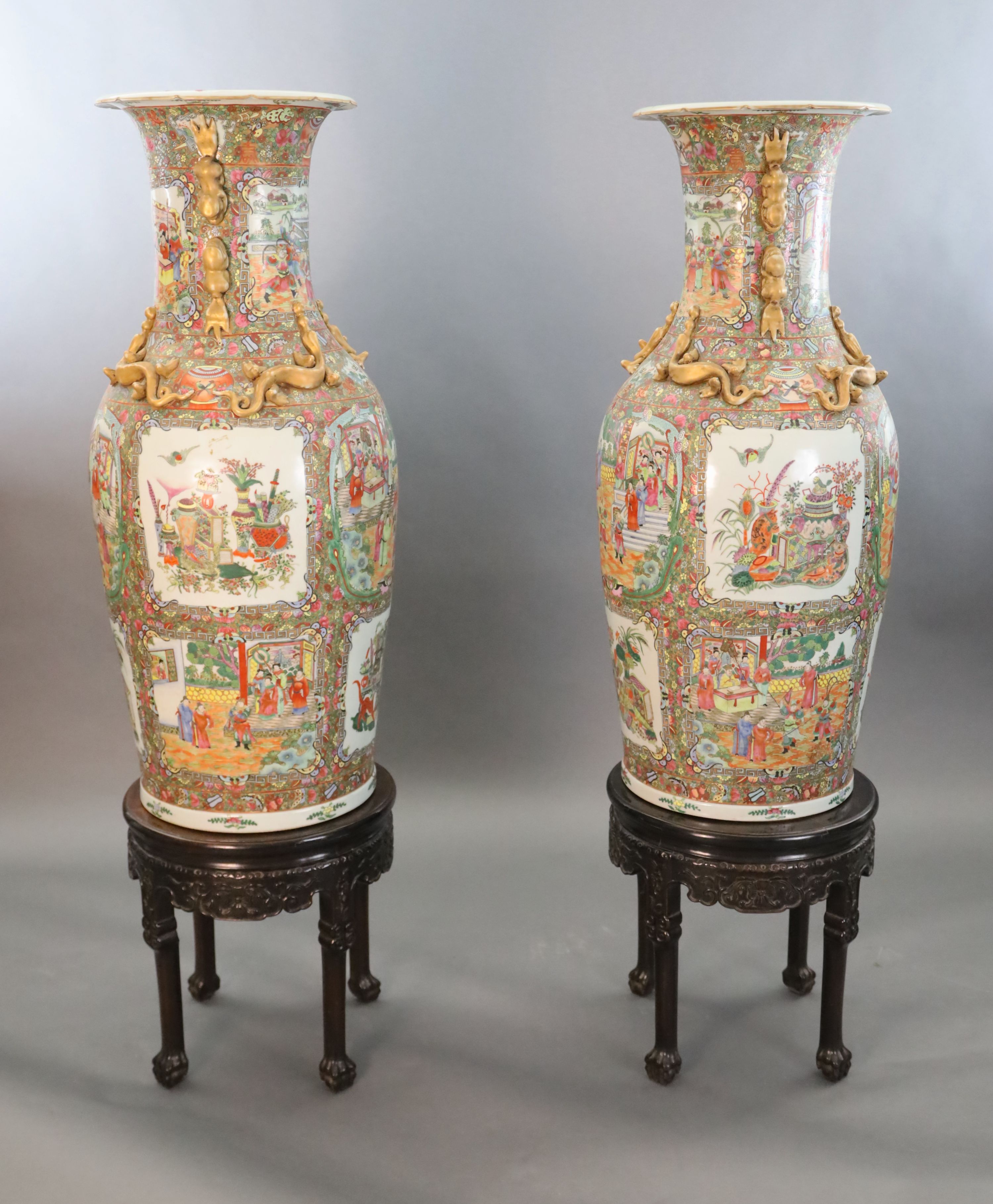 A pair of massive Chinese Canton style famille rose vases, 20th century and a pair of Chinese hongmu and marble stands, late 19th century